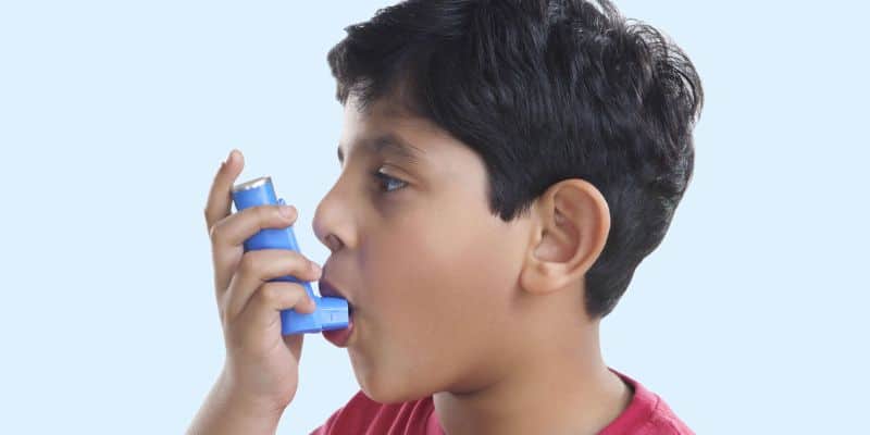 landscape   boy using asthma inhaler