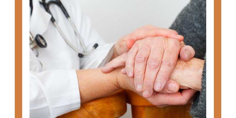 patient and doctor hold hands